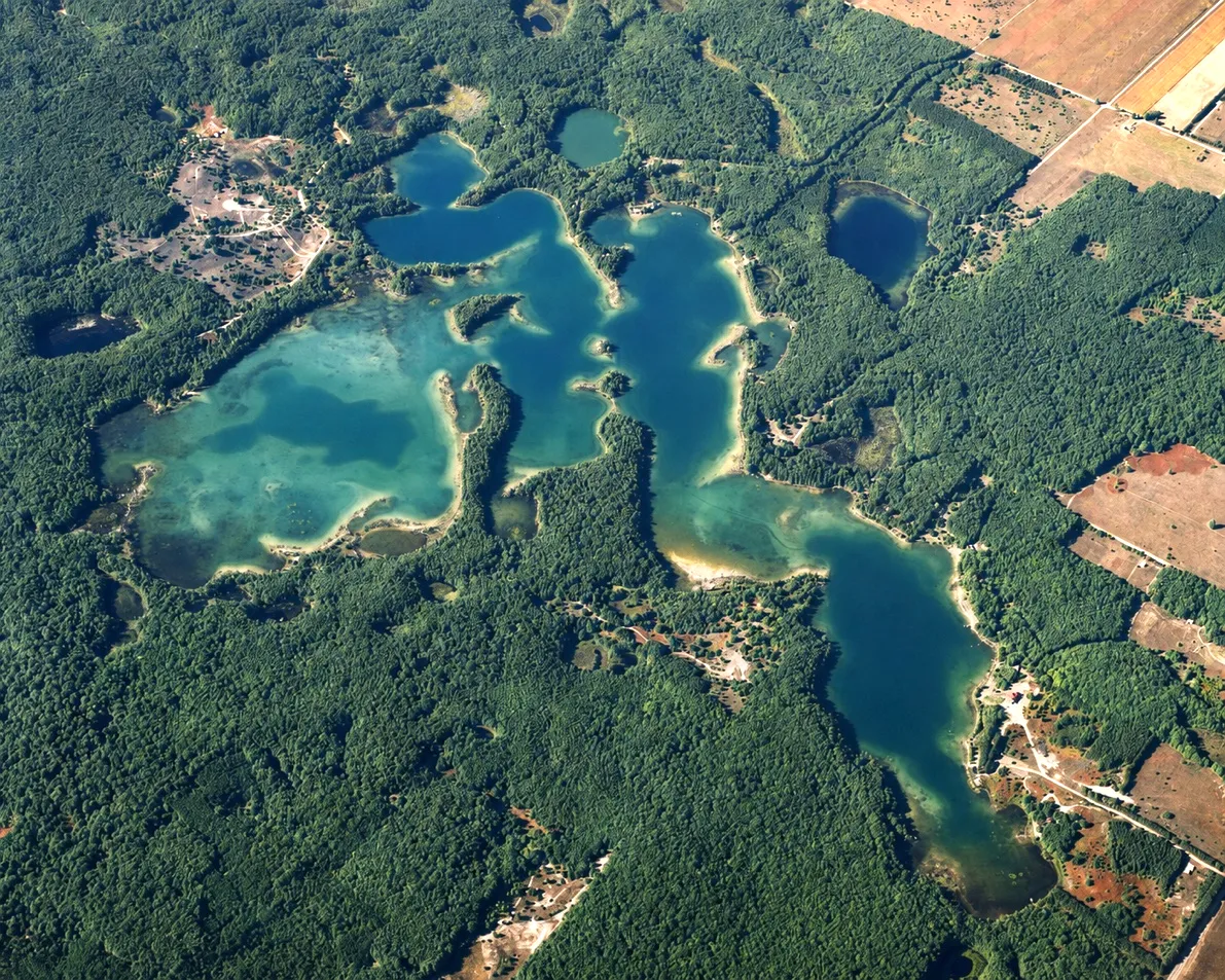 Aerial view of Pearl Lake's bays, wooded peninsulas, and protected shoreline in Benzie County, Michigan