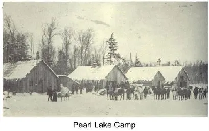 A historical photograph labeled Pearl Lake Camp, showing early buildings in winter