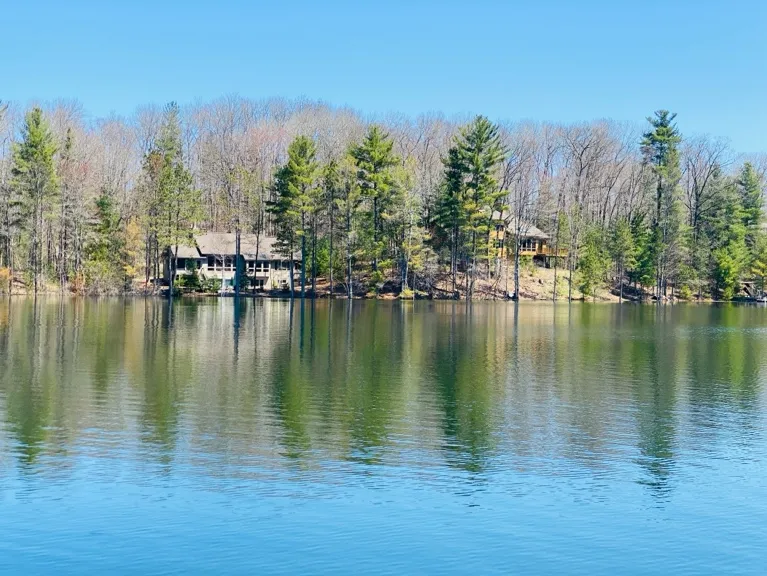 Spring green returning to the shoreline homes along Pearl Lake